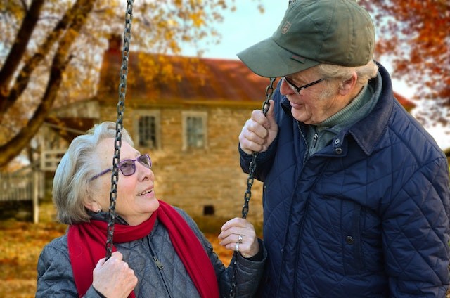 Two elderly people talking to each other