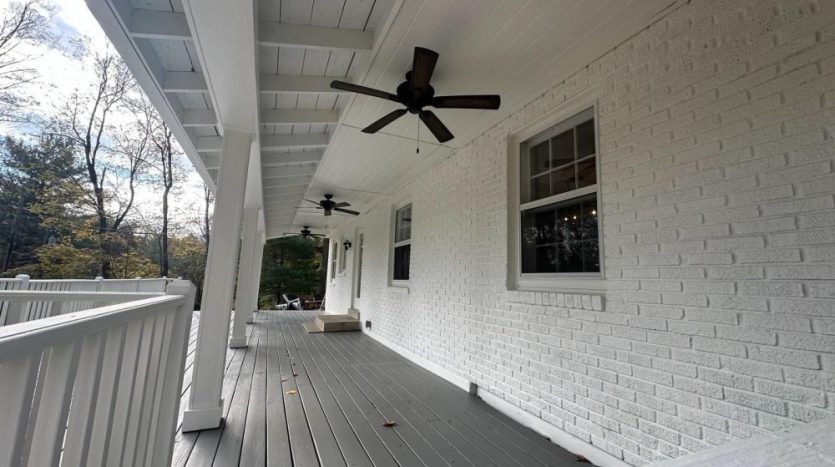 Covered porch with flat-painted brick wall and satin gray porch floor