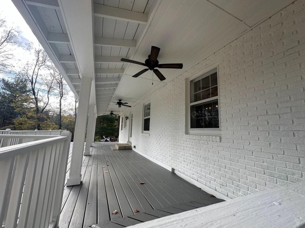 Covered porch with flat-painted brick wall and satin gray porch floor